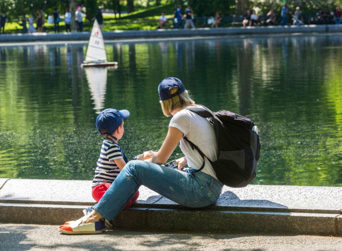 Mother and son watching model boats on Conservatory Water