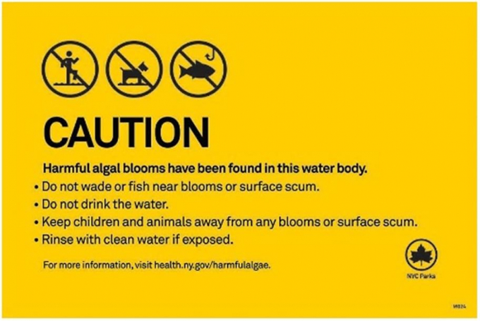 Example of a yellow caution sign regarding harmful algal blooms