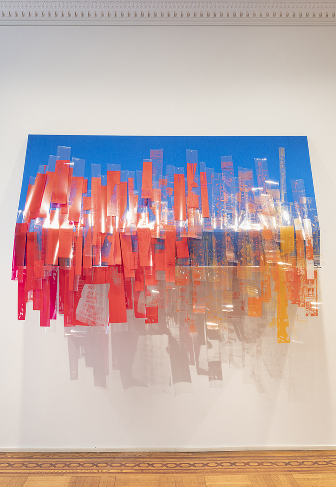 Photo of the artwork mounted on a gallery wall