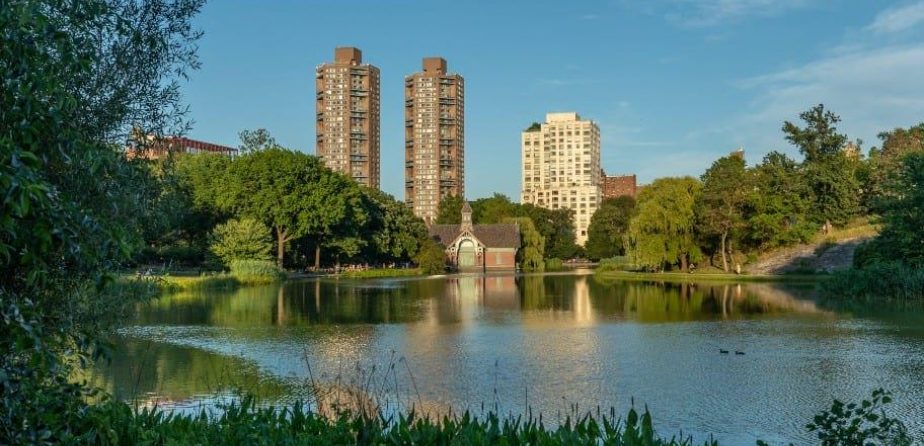 Harlem Meer in summer, with buildings in the background