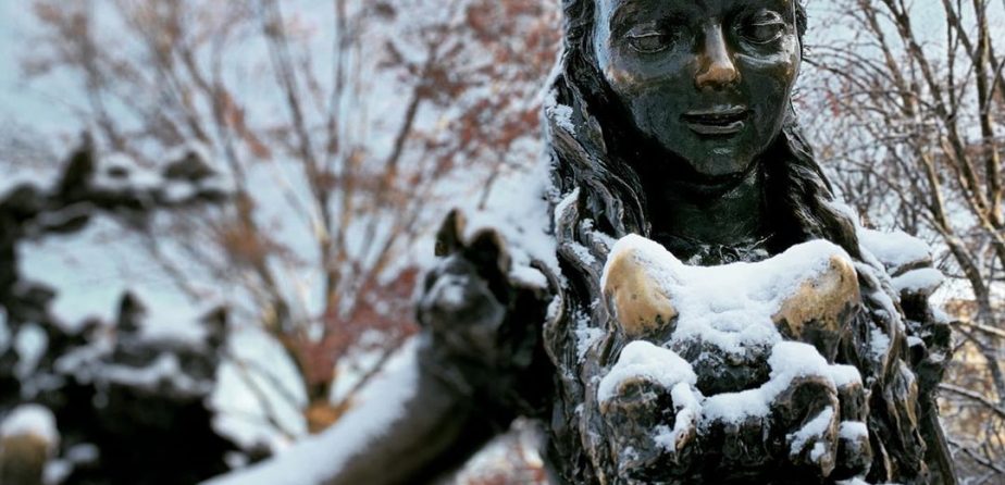 Alice in Wonderland statue in the snow